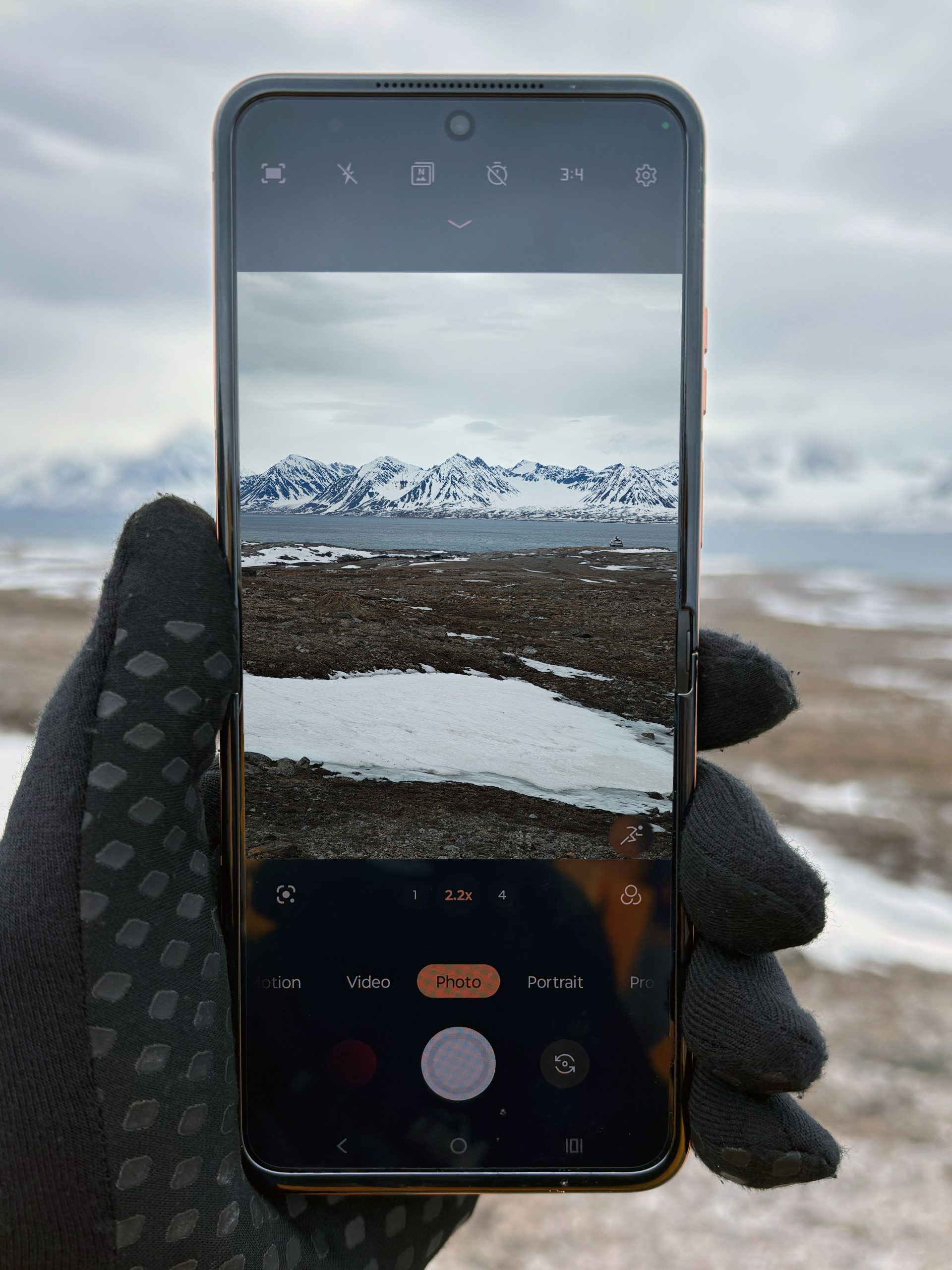 a picture of a person capturing an image with the razr 50 ultra in the North Pole